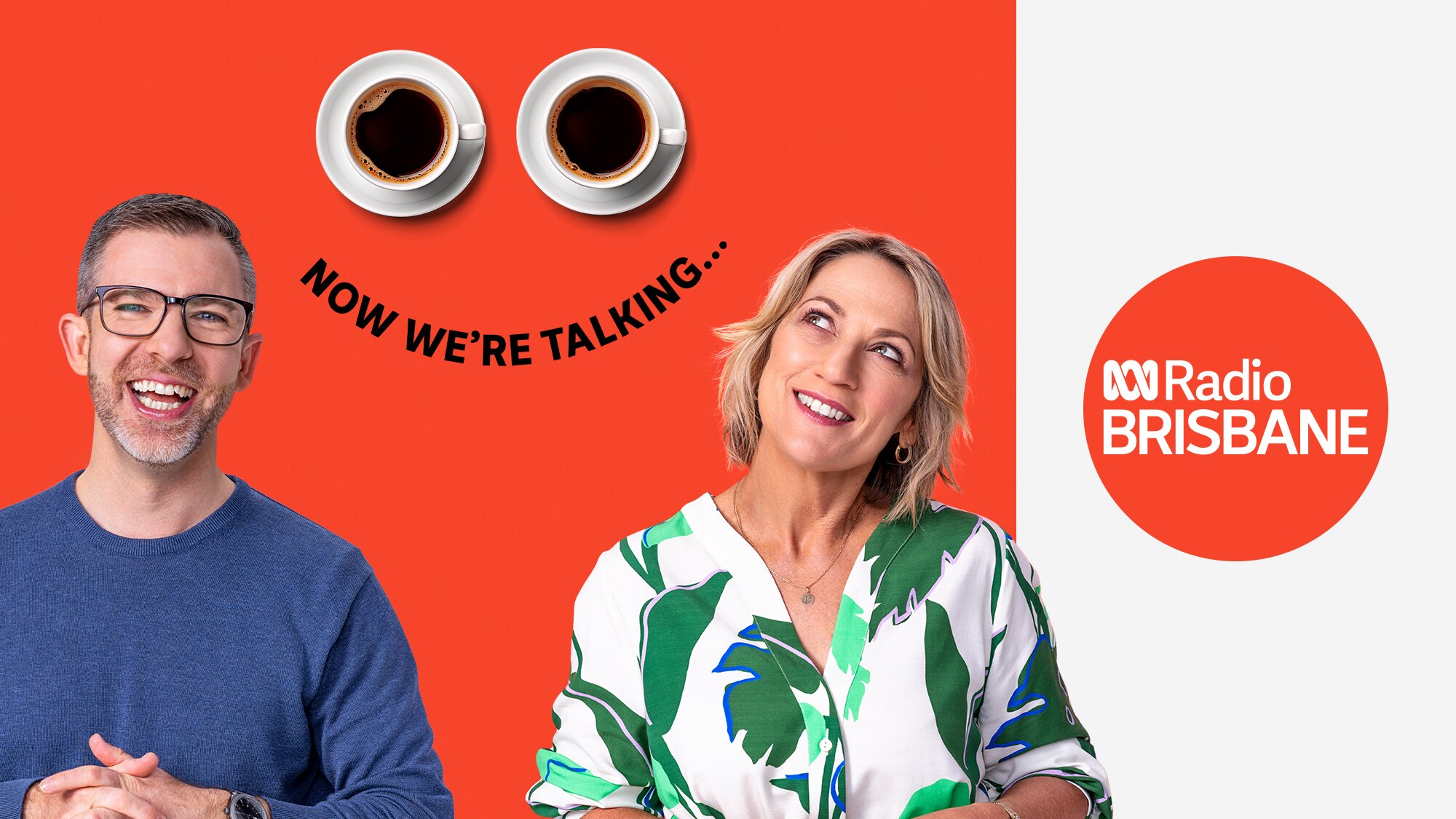 Man with beard wearing glasses and woman in green and white shirt, both smiling against orange background