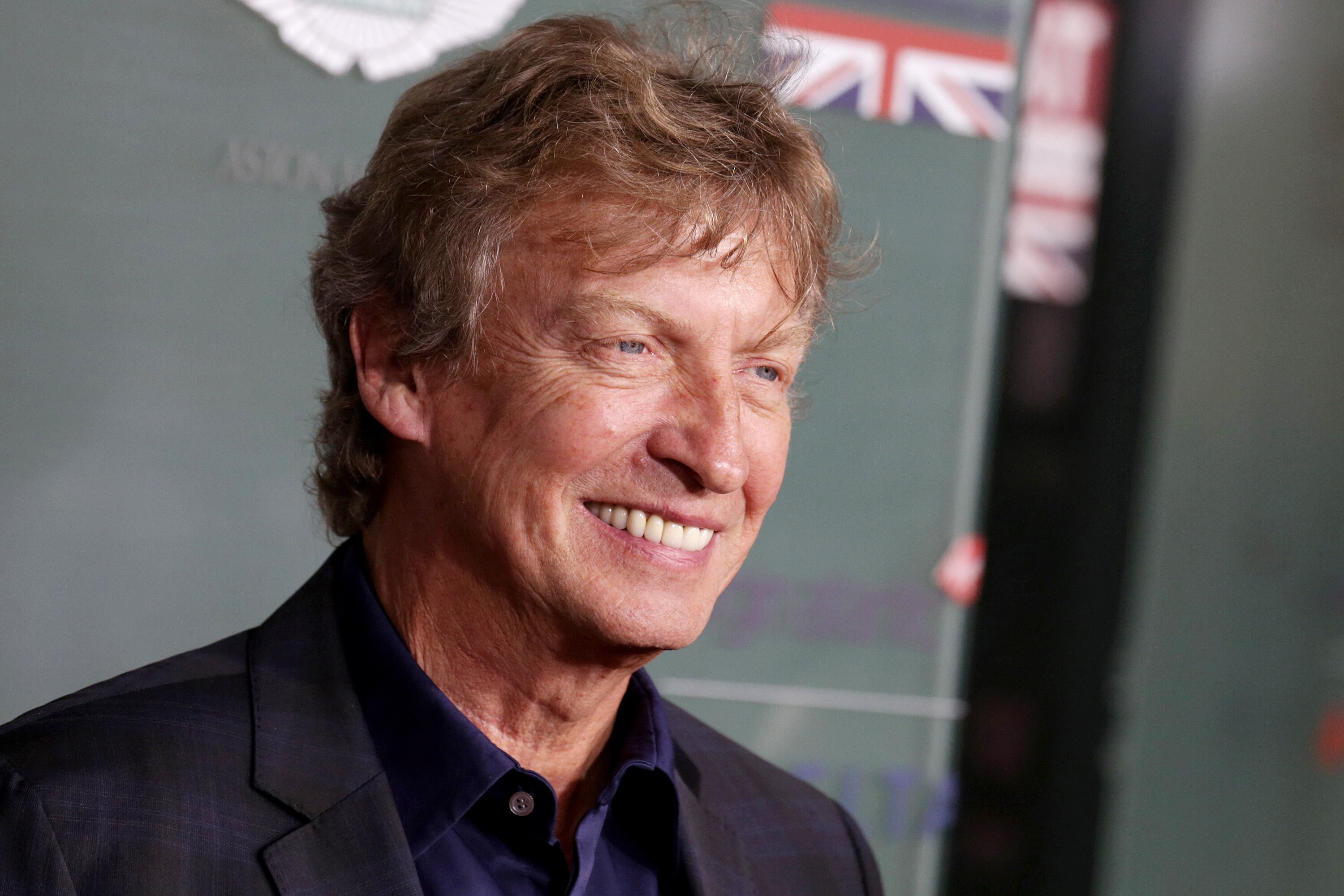 A close up of a smiling Nigel Lythgoe at a red carpet event
