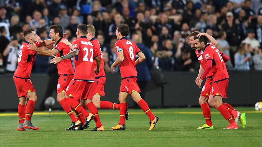 Adelaide United players celebrate a goal against Melbourne Victory on October 20, 2017.