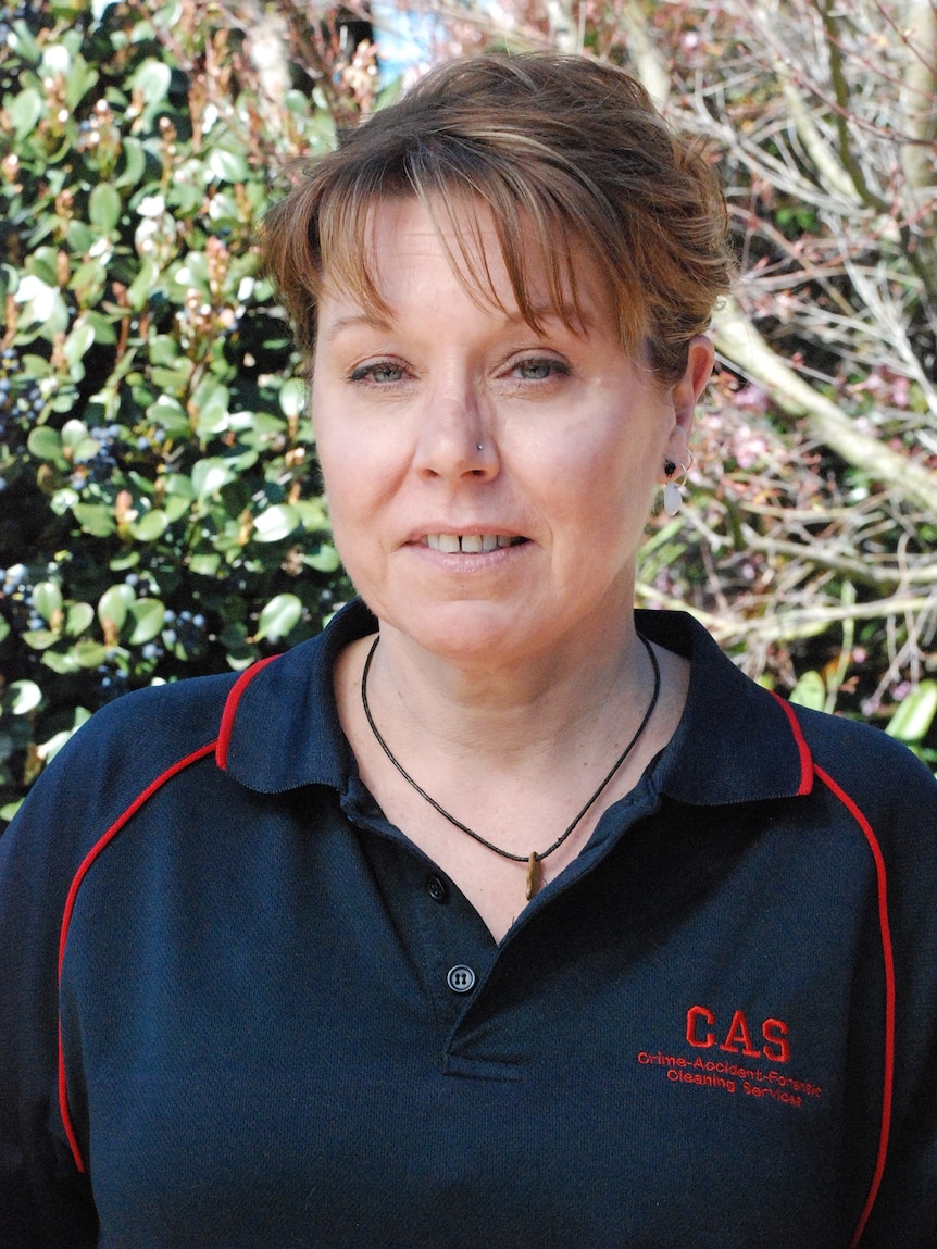 A woman wearing a blue polo shirt