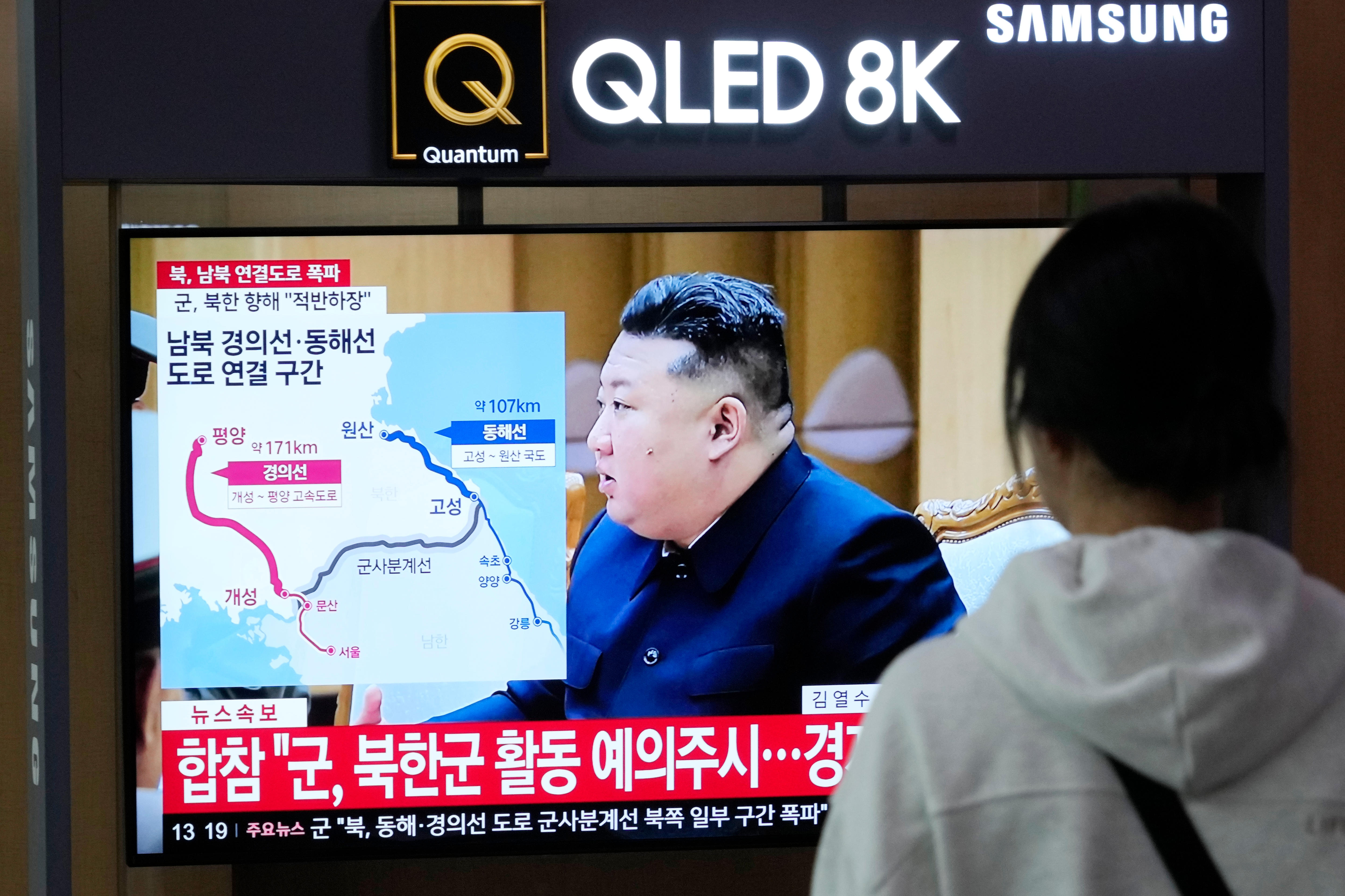 Kim Jong Un on a TV screen with a rail track graphic on it. 