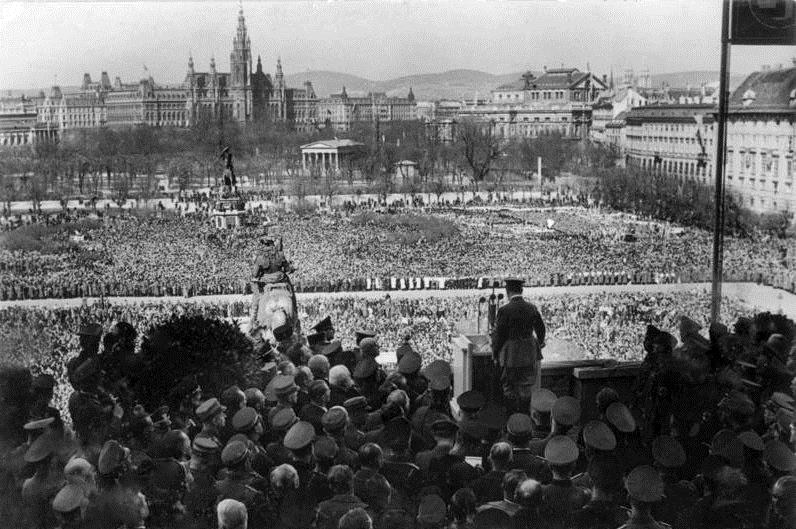 Archival image of Hitler giving a speech to a packed plaza of 200,000 Austrians in 1938