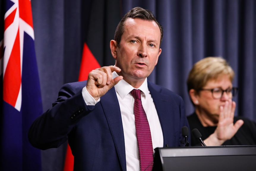 Mark McGowan pinching his fingers together while speaking.