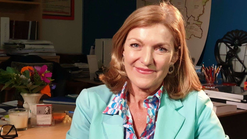 Fiona Patten, wearing a light blue jacket, smiles at the camera.