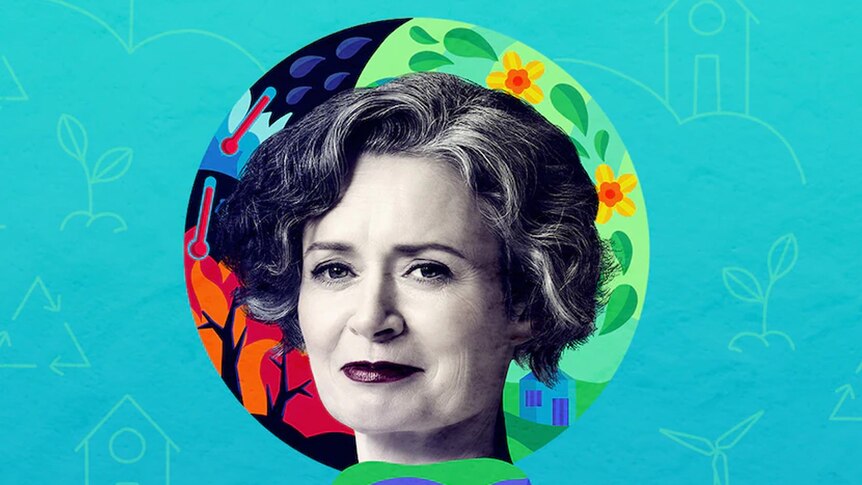 Judith Lucy's head is in front of a colourful circle. The background is blue. She is smiling slightly.