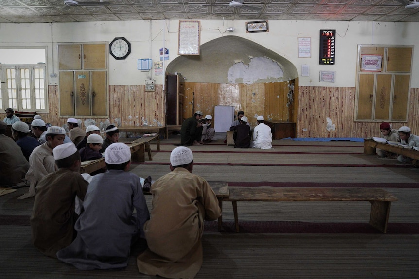 A room filled with boys studying the Koran