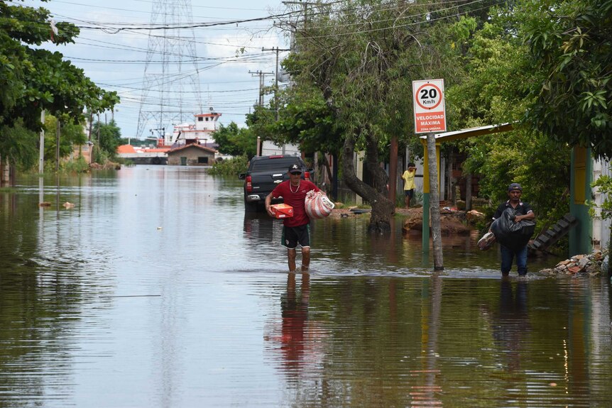 Residents flee after floods sweep through Latin America