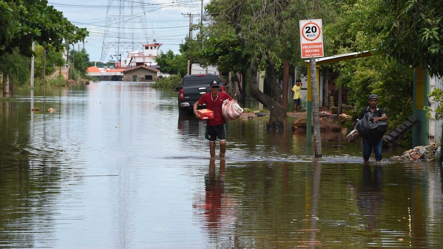 Residents flee after floods sweep through Latin America