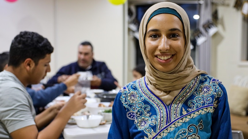 a woman with her head covered smiling