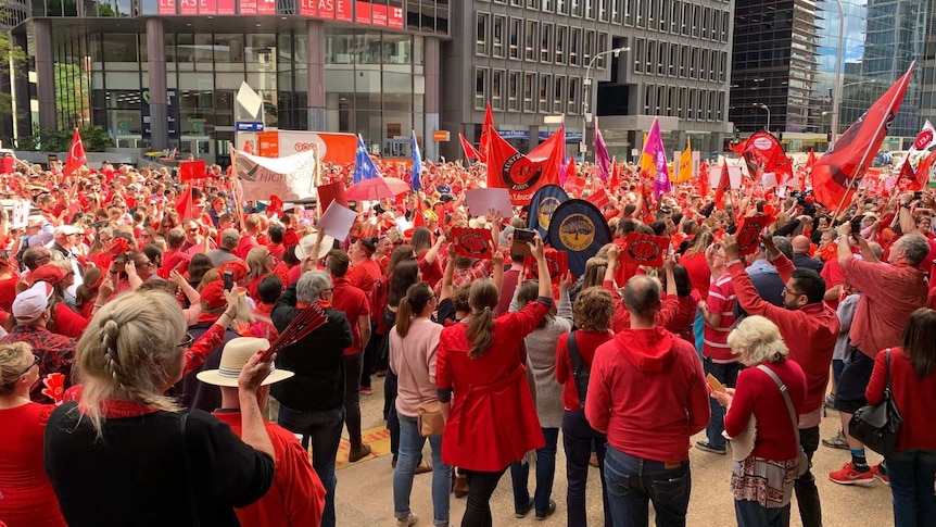 Thousands of teachers dressed in red are protesting.