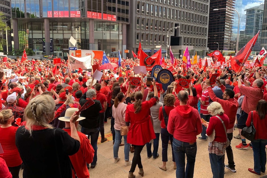 Thousands of teachers dressed in red are protesting.