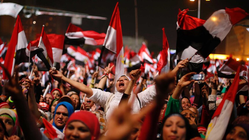 Egyptians react to the army's announcement in Tahrir Square