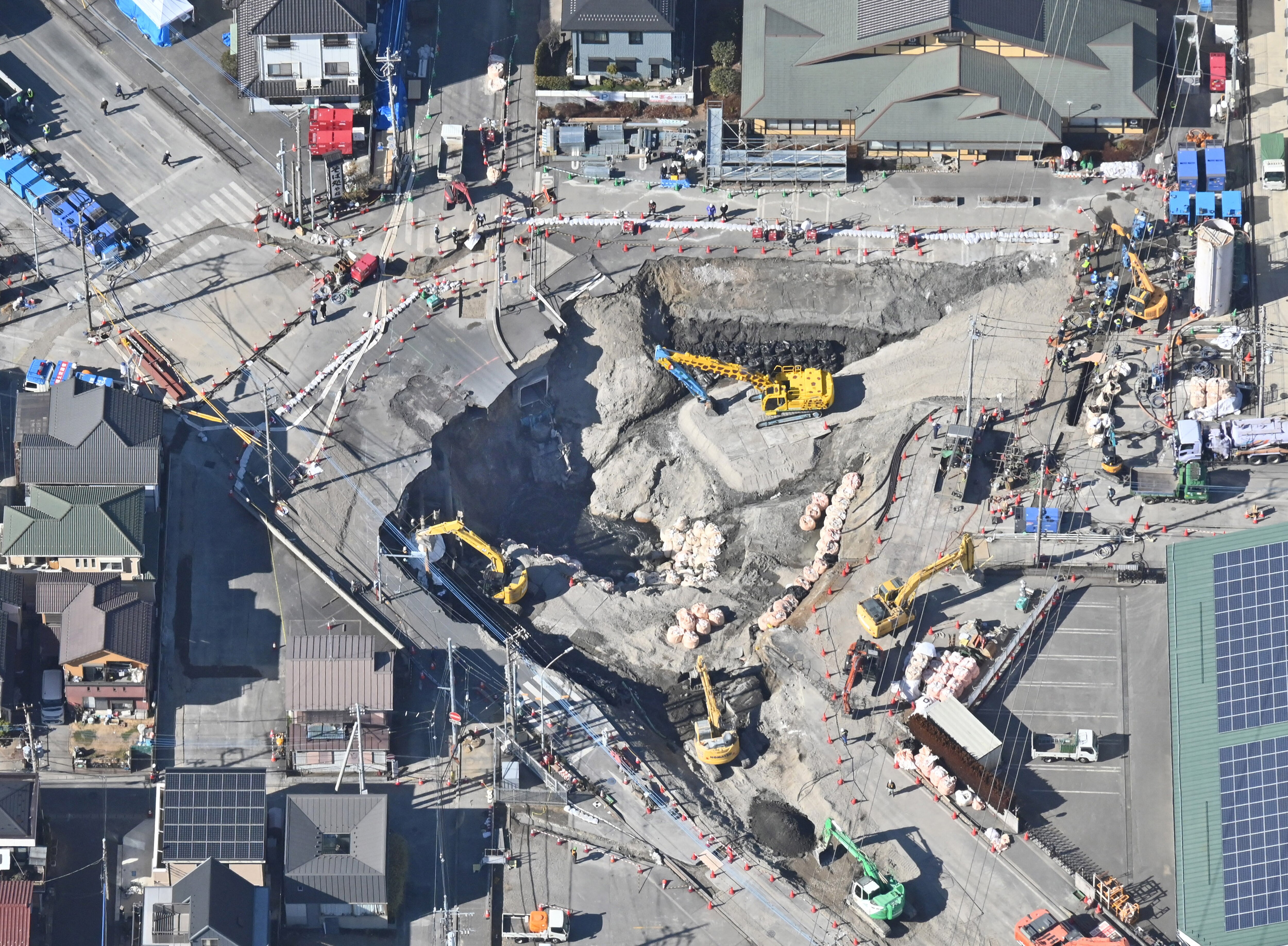 Rescuers battle sewage in hunt for truck driver swallowed by sinkhole