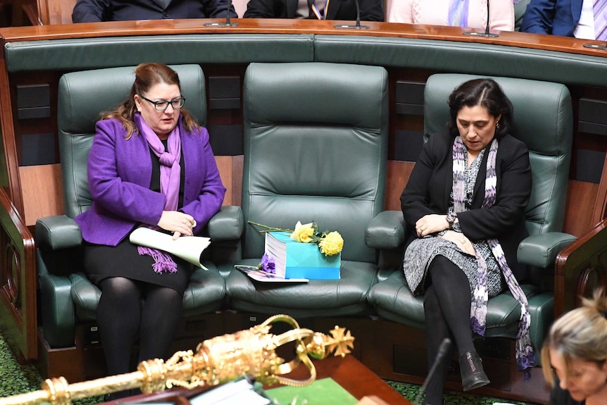 Yellow roses and a copy of the findings of the royal commission into family violence on Fiona Richardson's seat.