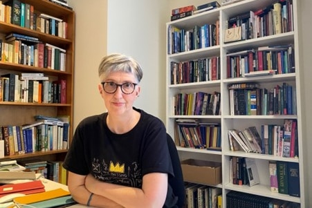 Professor Alison Young sitting in front of a bookcase in a supplied photo.