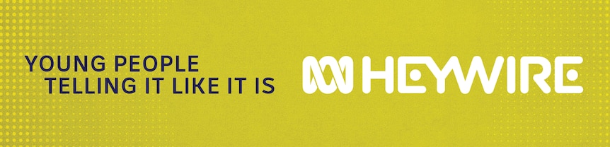A green background is seen with the word Heywire written in white and young people telling it like it is written in blue.
