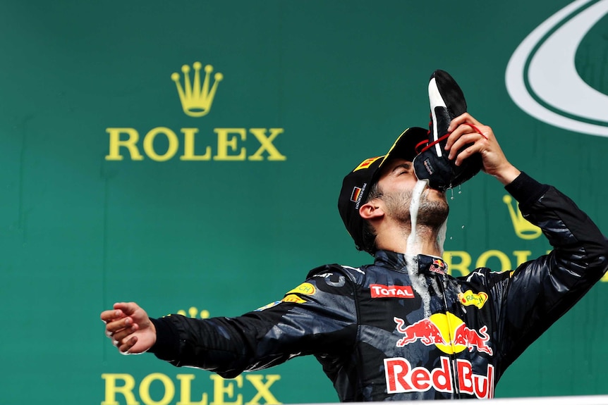 Daniel Ricciardo drinks champagne out of his boot after the German Grand Prix