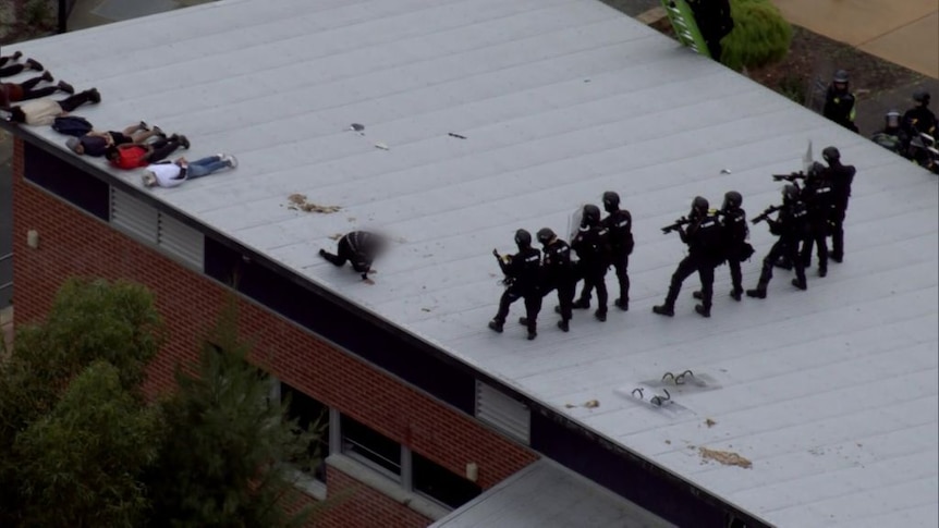 Vision shows armed riot squad officers arresting detainees on Banksia Hill roof