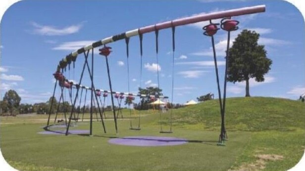 A curved piece of play equipment with swings hanging from it.
