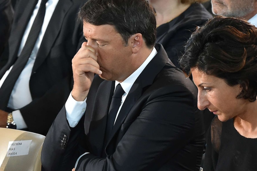 Italian Prime Minister Matteo Renzi (L) and his wife Agnese react during a funeral service for victims of the earthquake.