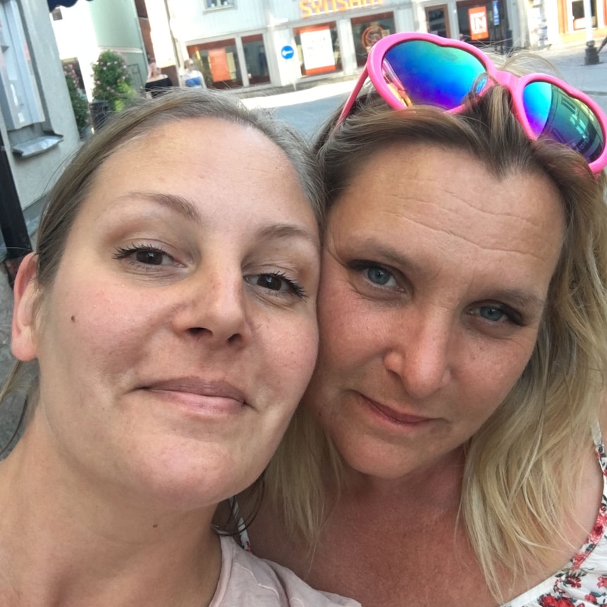 Two women pose for a selfie.