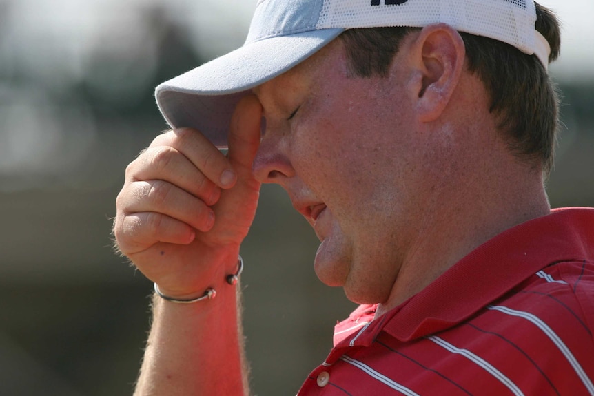 Jarrod Lyle wipes his brow with his eyes closed