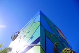 A colourful, triangular building.