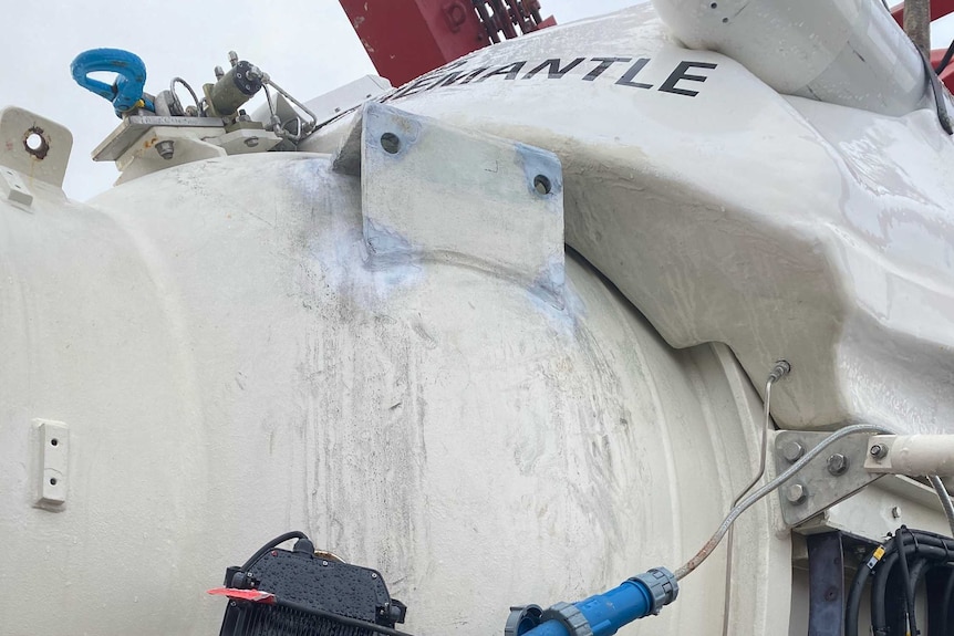 A submersible vessel sits on the deck of a boat