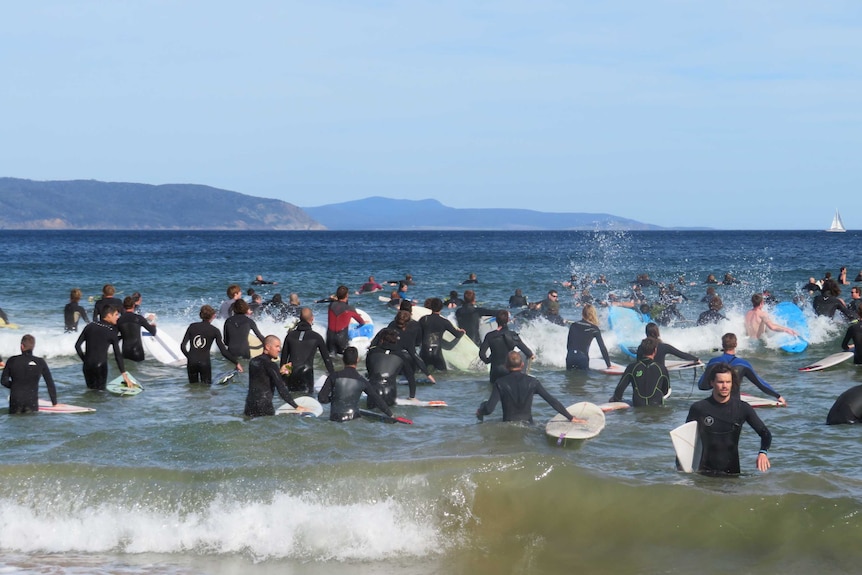 Surfers heading out from Clifton Beach