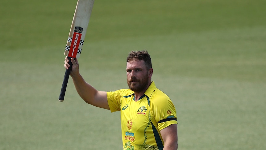 Australia batter Aaron Finch raise his bat as he walks off the field in a one-day international against New Zealand.