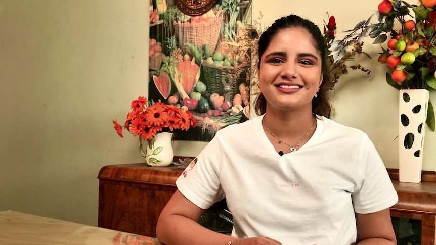 A woman of Indian desent looking at the camera. 