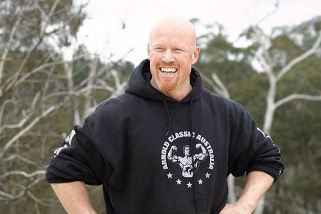 A bald man with a ginger beard in a hoodie.