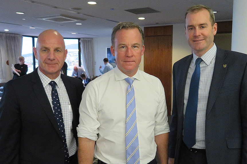 Treasurer Peter Gutwein, Premier Will Hodgman and Health Minister Michael Ferguson standing together.