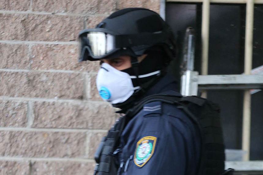 A police officer wearing a breathing mask