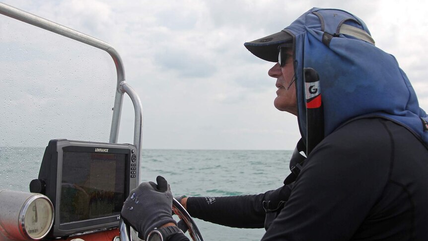 A photo of Rick Trippe driving his boat out to see in Darwin.