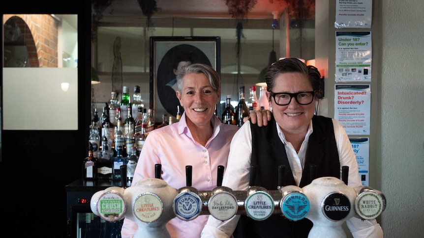 two women behind a pub bar