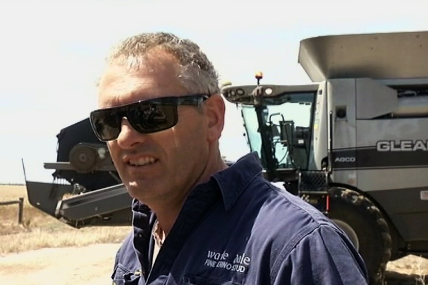 Farmer David Vandenburghe picutred in front of farming machinery.
