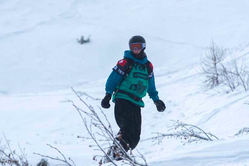 Snowboarder heads down hill