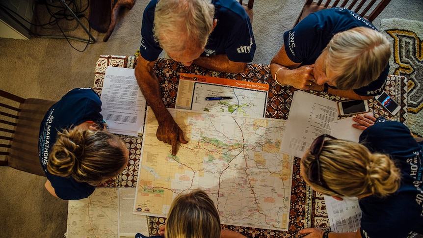 A team of planners map out marathon runner Mina Guli's route.