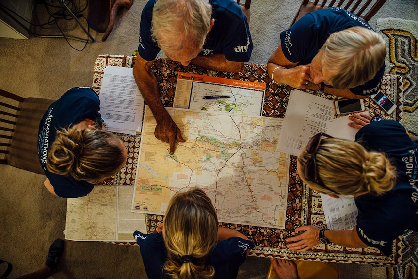 A team of planners map out marathon runner Mina Guli's route.