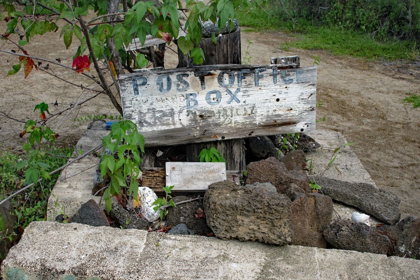 A close up of the post box in the Galapagos, built together with rocks and wood.