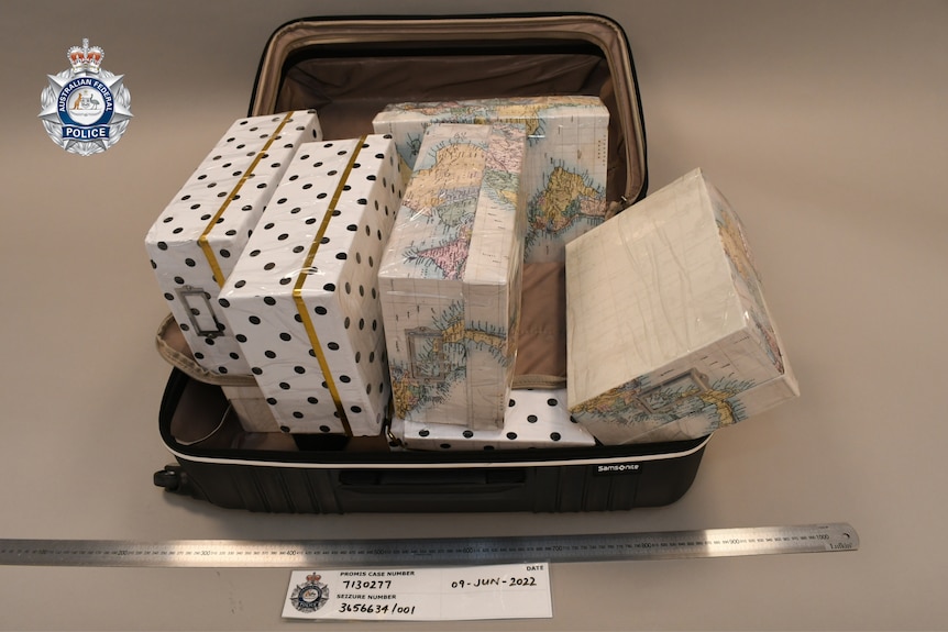 A police supplied image of five shoeboxes in a suitcase.