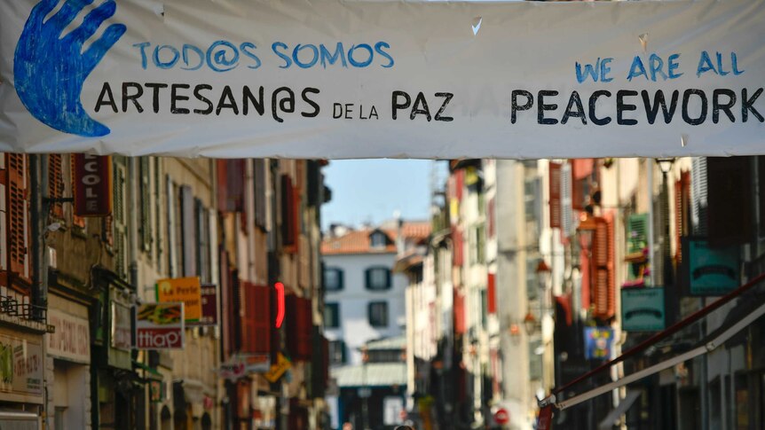 Basques seen at a rally in Bayonne, France, walking under a banner that reads ''All people are Artisans of the Peace''.