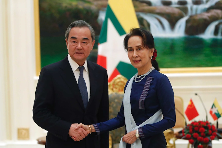 Myanmar's leader Aung San Suu Kyi, right, shakes hands with Chinese Foreign Minister Wang Yi, left.