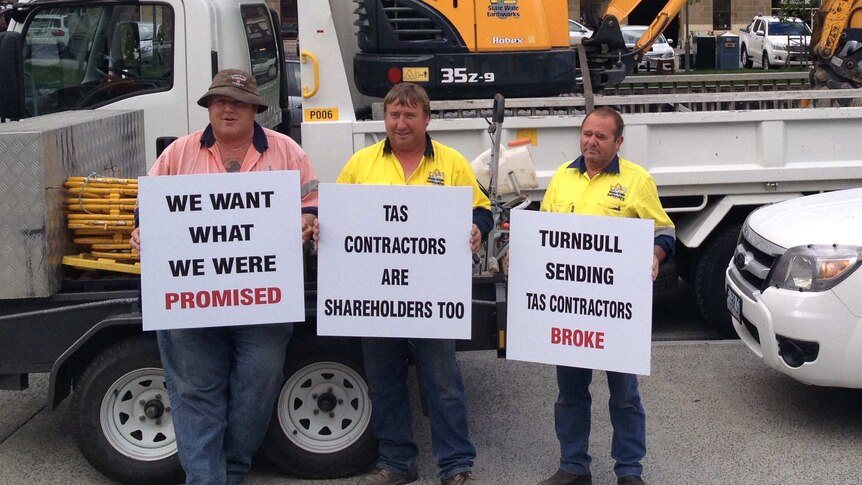 Tasmanian NBN contractors hold signs at a protest in Hobart's Salamanca Place.