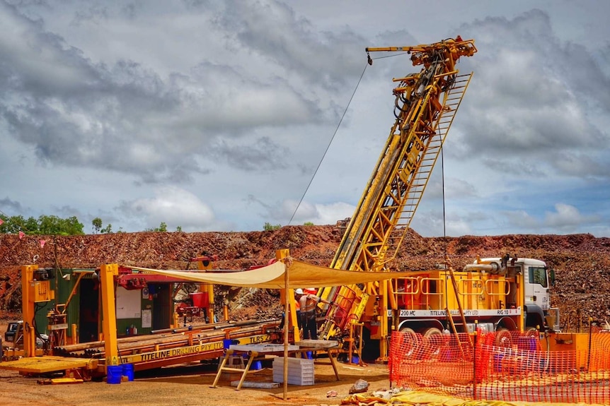 A large diamond driller is operated by workmen to extract 20 tonnes of ore at the Mt Todd site.