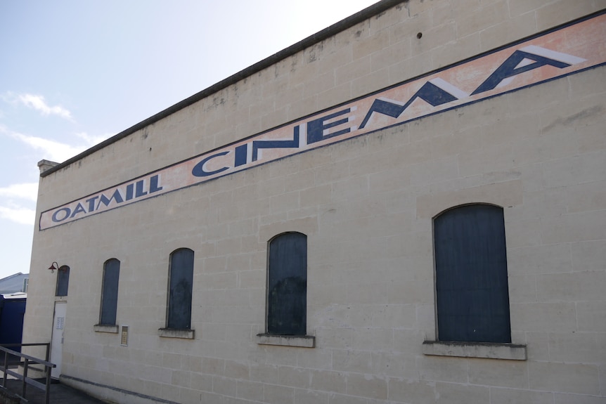 The exterior of the Oatmill Cinema with a painted sign.