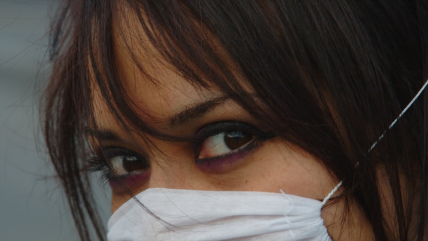 A woman wearing a face mask.