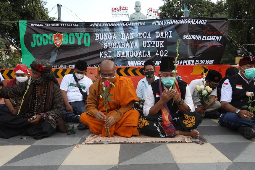 Various religious leaders hold a prayer session on the street
