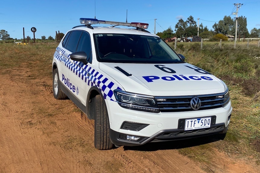 police car on dirt road